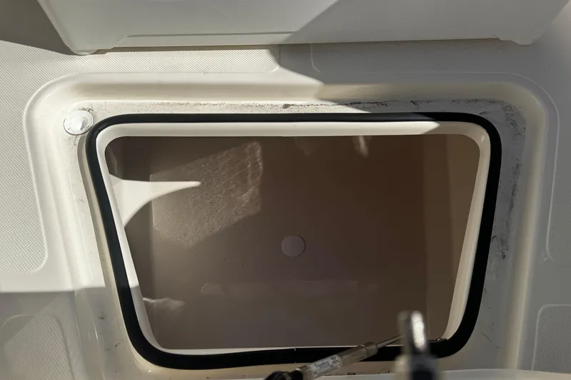 Slide: The Image of Open storage compartment on 2026 Pioneer 222 Islander boat, featuring a clean interior. - 33