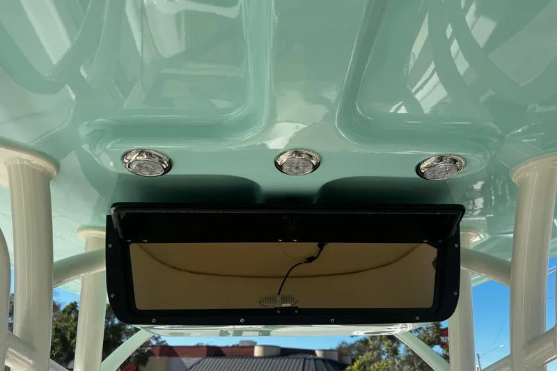 Slide: The Image of 2026 Pioneer 222 Islander boat interior with ceiling lights and storage compartment. - 34
