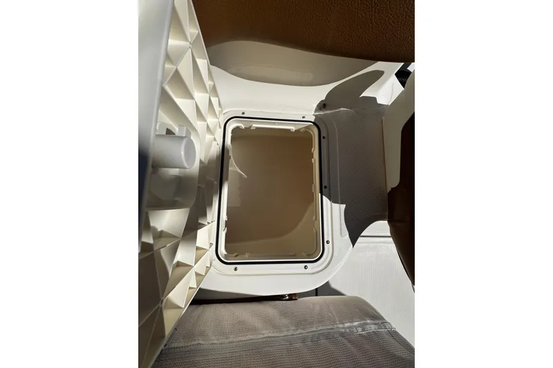 Slide: The Image of Open storage compartment in 2026 Pioneer 222 Islander boat interior. - 38