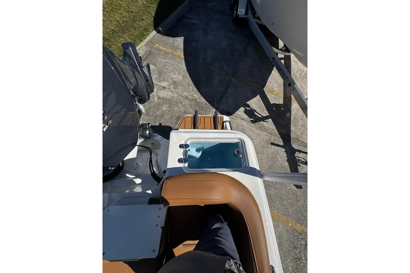 Slide: The Image of 2026 Pioneer 222 Islander boat interior with seating and engine view. - 41