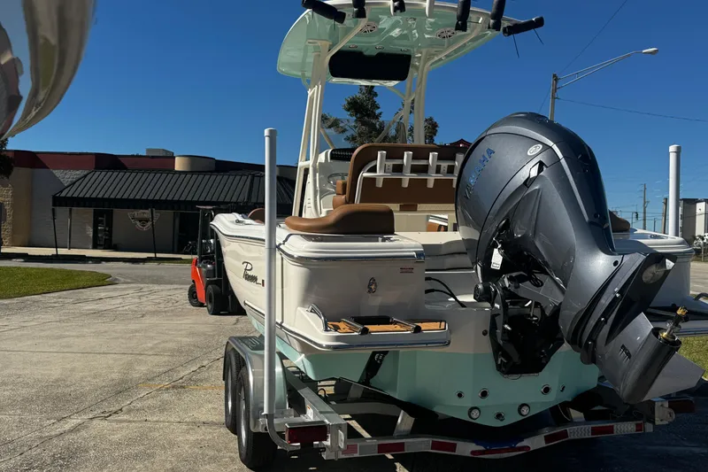 Slide: The Image of 2026 Pioneer 222 Islander boat on trailer with Yamaha outboard motor, parked outdoors. - 5