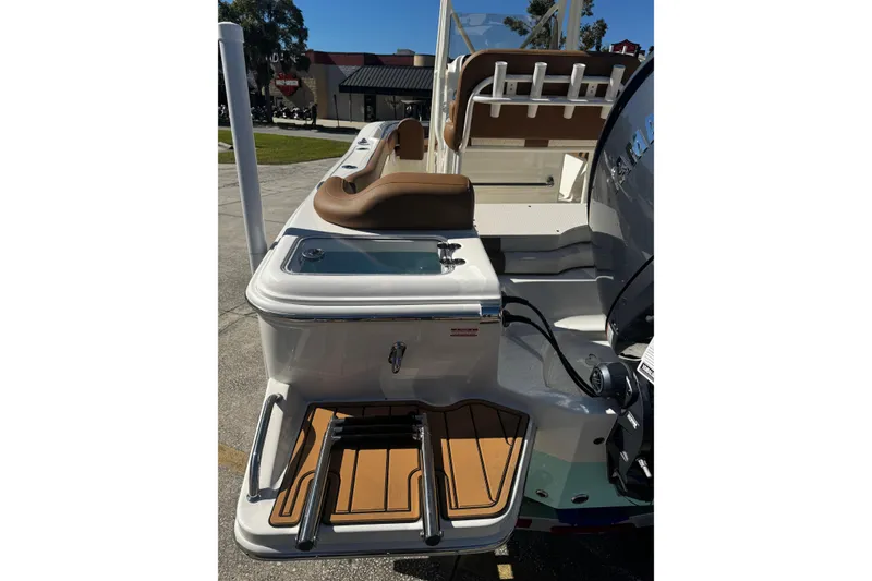 Slide: The Image of 2026 Pioneer 222 Islander boat with seating, storage, and motor, displayed outdoors. - 6
