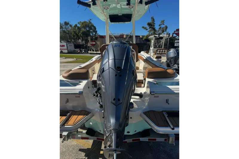 Slide: The Image of 2026 Pioneer 222 Islander boat with powerful outboard motor, docked outdoors. - 7