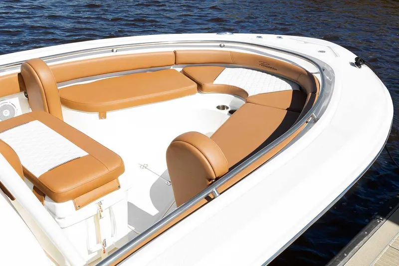 Slide: The Image of Manufacturer Provided Image: 2025 Pioneer 222 Islander boat with tan seating, docked on calm water. - 9