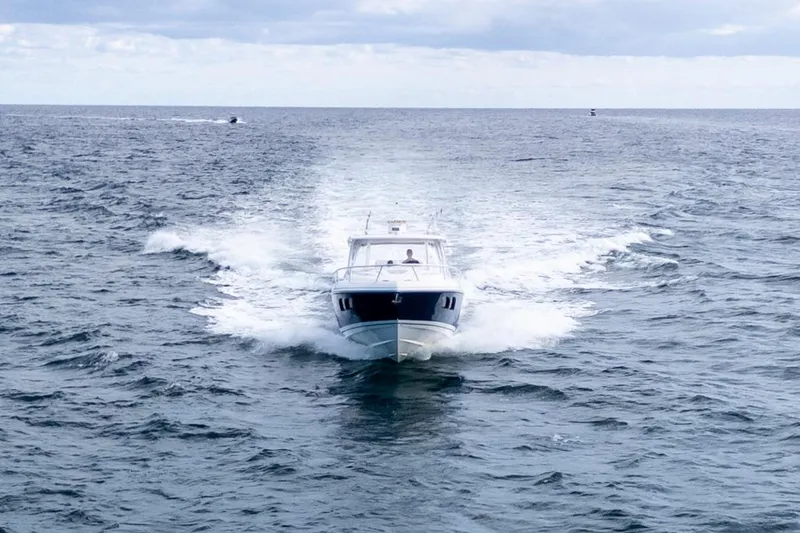 Slide: The Image of 2019 Intrepid 407 Cuddy cruising on open ocean under cloudy sky. - 10