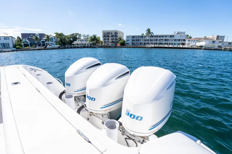 Slide: The Image of 2019 Intrepid 407 Cuddy boat with triple Yamaha 300 engines on a sunny waterfront. - 18