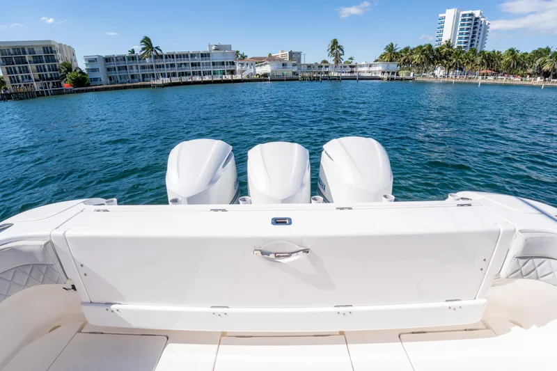 Slide: The Image of 2019 Intrepid 407 Cuddy boat with triple engines on a sunny waterfront. - 19