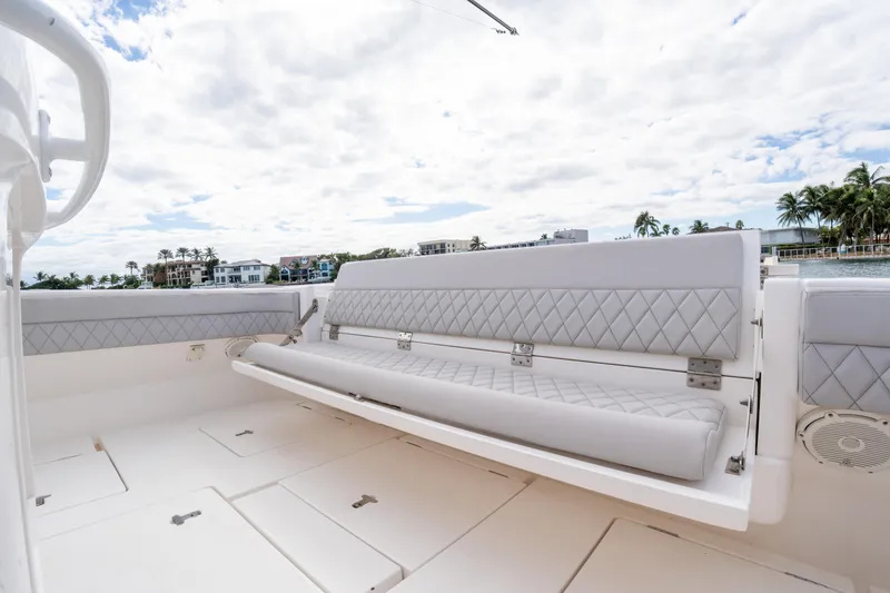 Slide: The Image of 2019 Intrepid 407 Cuddy boat with luxurious seating and scenic waterfront view. - 21