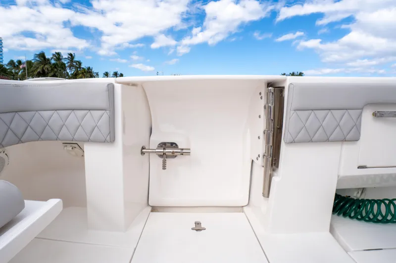 Slide: The Image of 2019 Intrepid 407 Cuddy boat interior with quilted seating and blue sky background. - 24