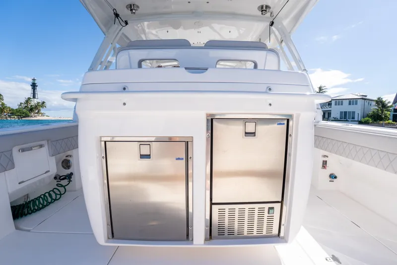 Slide: The Image of 2019 Intrepid 407 Cuddy boat interior with stainless steel storage, ocean view. - 25