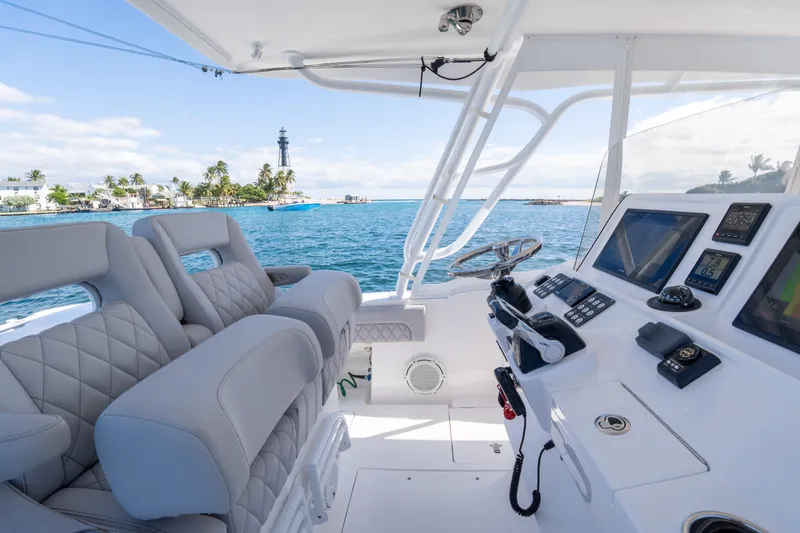 Slide: The Image of 2019 Intrepid 407 Cuddy boat interior with ocean view and lighthouse in background. - 28
