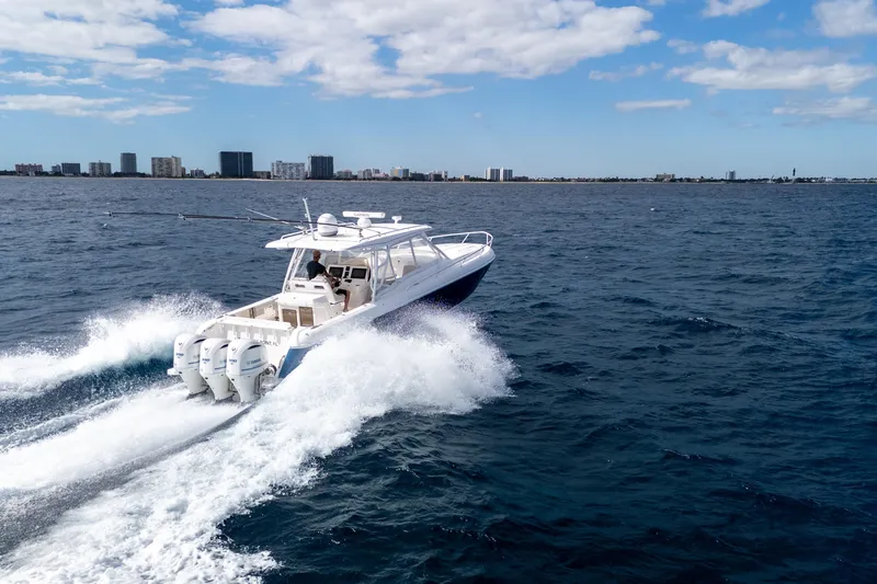 Slide: The Image of 2019 Intrepid 407 Cuddy cruising on open water under a clear sky. - 3