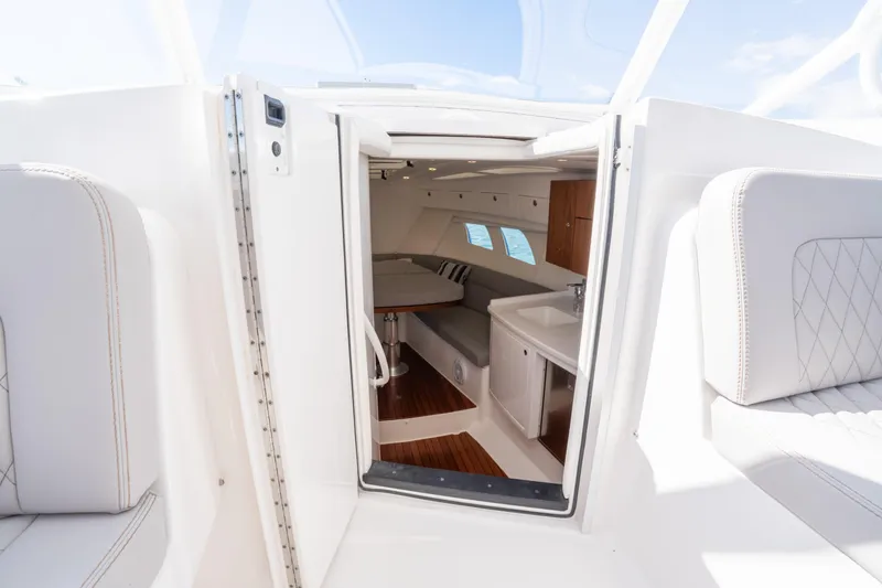 Slide: The Image of Interior view of 2019 Intrepid 407 Cuddy boat, featuring seating and kitchenette. - 32