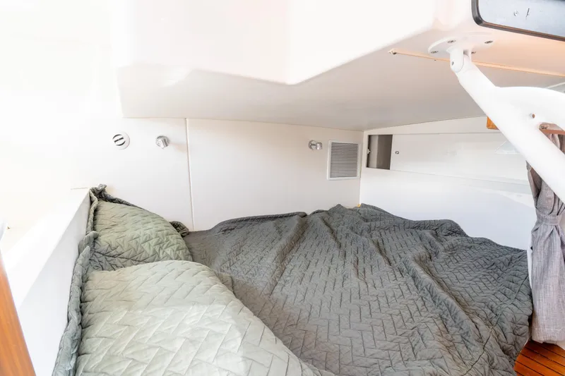 Slide: The Image of 2019 Intrepid 407 Cuddy cabin interior with cozy bedding and modern design. - 38