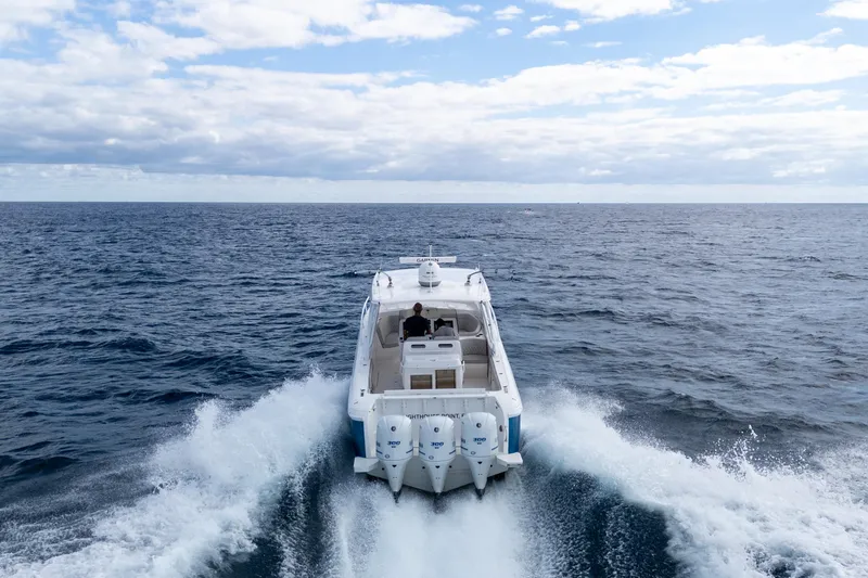 Slide: The Image of 2019 Intrepid 407 Cuddy cruising on open ocean under cloudy sky. - 4