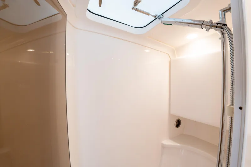 Slide: The Image of Interior of 2019 Intrepid 407 Cuddy boat, featuring a sleek, modern shower area. - 42