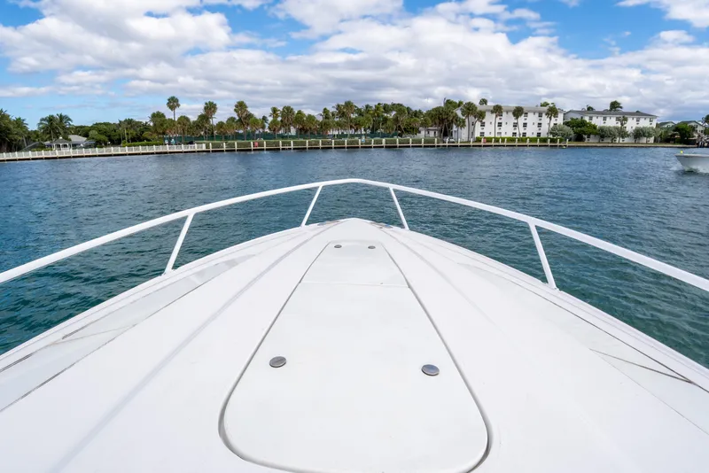 Slide: The Image of Bow view of 2019 Intrepid 407 Cuddy on calm water, with scenic shoreline. - 43