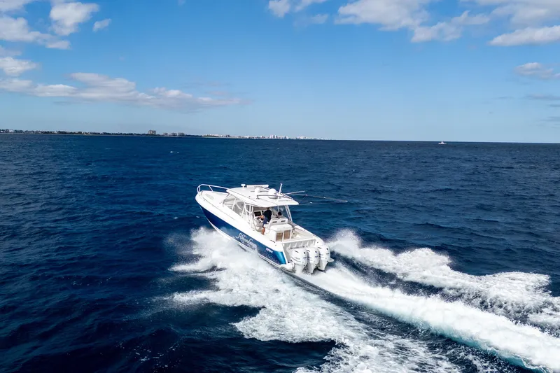 Slide: The Image of 2019 Intrepid 407 Cuddy cruising on open ocean under blue sky. - 6