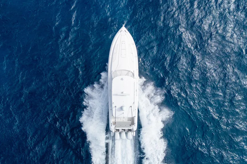 Slide: The Image of Aerial view of 2019 Intrepid 407 Cuddy boat cruising on open blue ocean. - 7