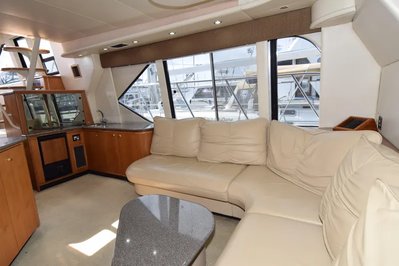 Slide: The Image of Luxurious interior of 1999 Bayliner 5288 yacht with cream leather seating and large windows. - 1