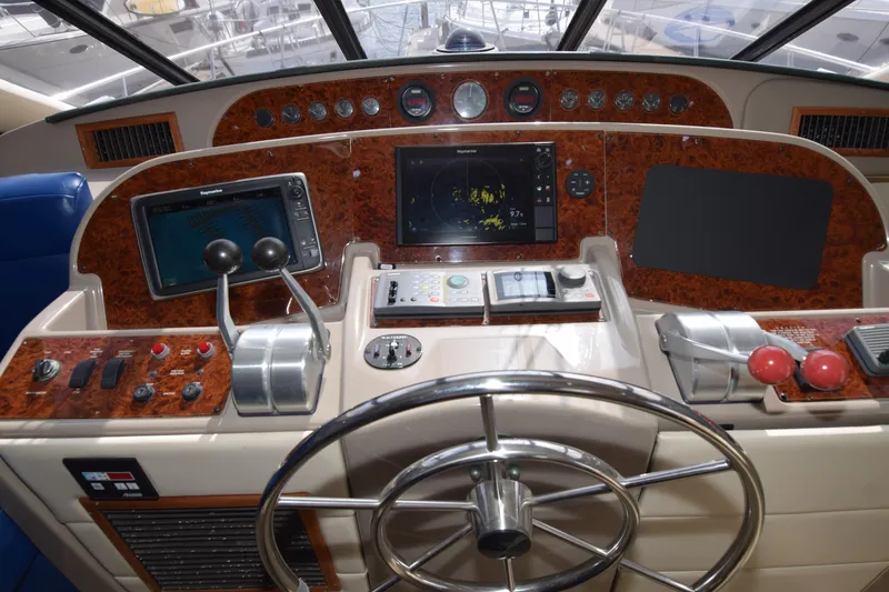 Slide: The Image of 1999 Bayliner 5288 yacht helm with navigation controls and steering wheel. - 12