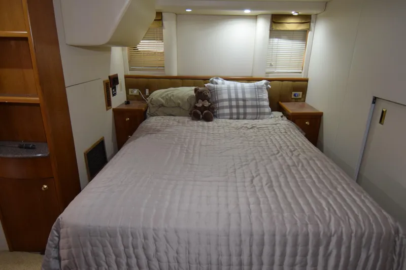 Slide: The Image of Cozy bedroom in 1999 Bayliner 5288 yacht with plush bedding and soft lighting. - 13