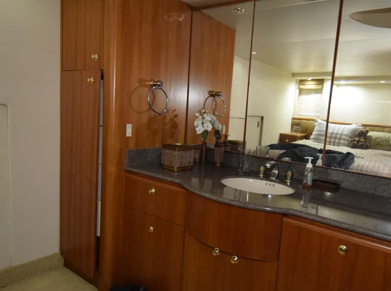Slide: The Image of Luxurious bathroom interior of 1999 Bayliner 5288 yacht with wooden cabinetry and modern fixtures. - 15
