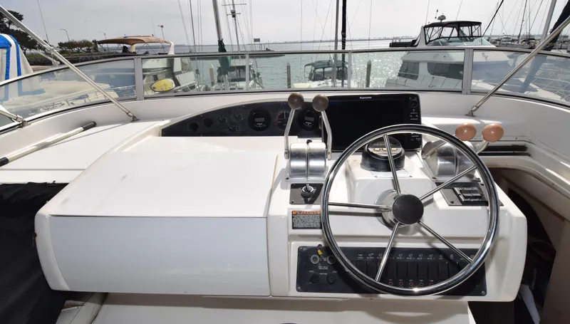 Slide: The Image of 1999 Bayliner 5288 yacht helm with steering wheel and control panel. - 20