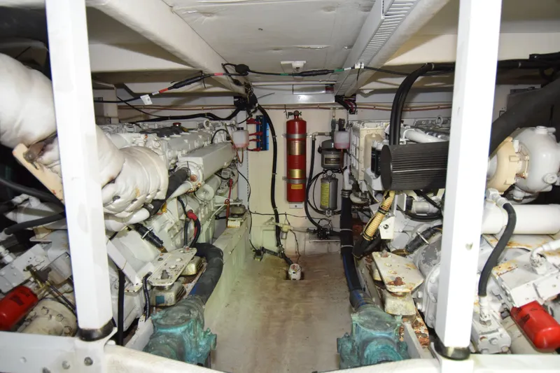 Slide: The Image of Engine room of 1999 Bayliner 5288 yacht, featuring dual engines and fire suppression system. - 24