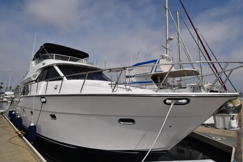 Slide: The Image of 1999 Bayliner 5288 yacht docked at marina under cloudy sky. - 25