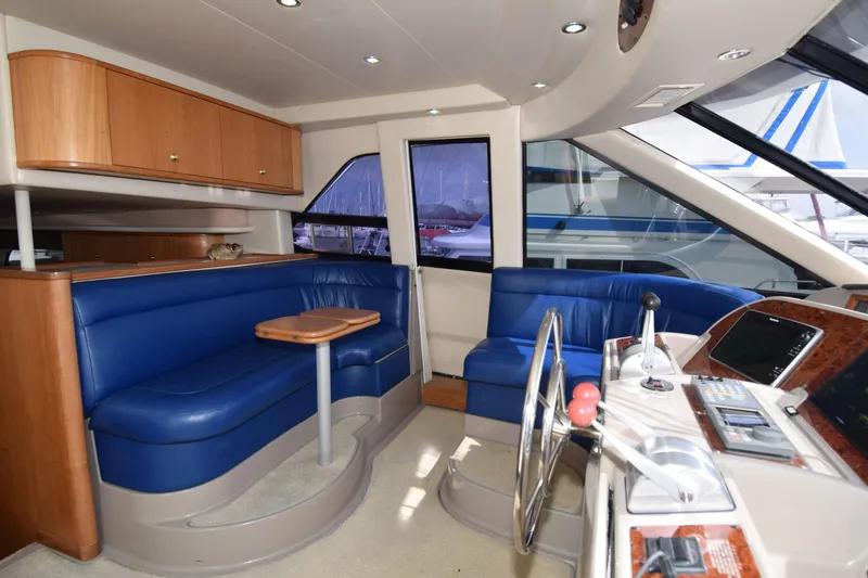 Slide: The Image of Interior of 1999 Bayliner 5288 yacht with blue seating and wooden accents. - 4