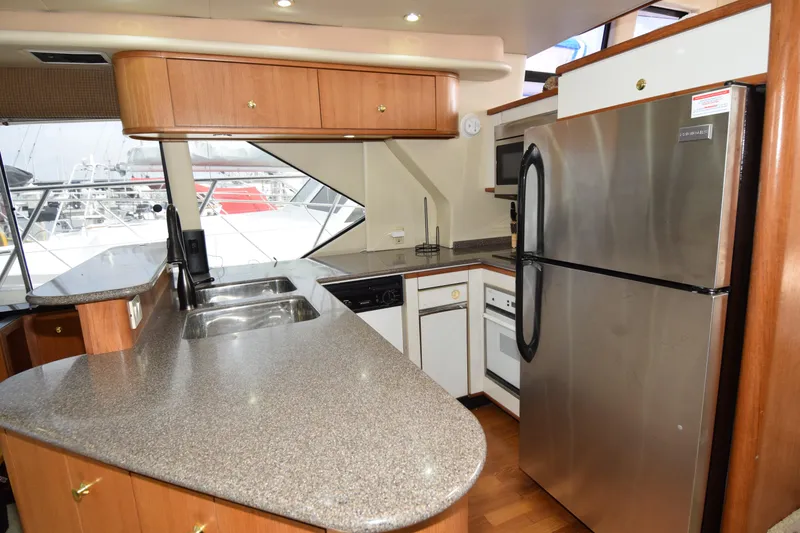 Slide: The Image of 1999 Bayliner 5288 yacht kitchen with modern appliances and spacious countertops. - 6