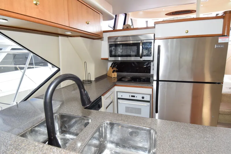 Slide: The Image of 1999 Bayliner 5288 yacht kitchen with stainless steel appliances and dual sink. - 8