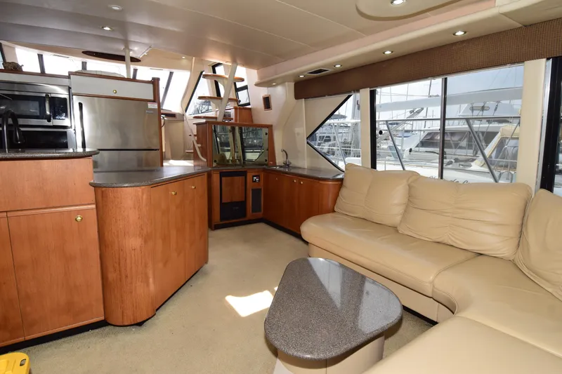 Slide: The Image of Luxurious interior of a 1999 Bayliner 5288 yacht with modern kitchen and comfortable seating. - 9