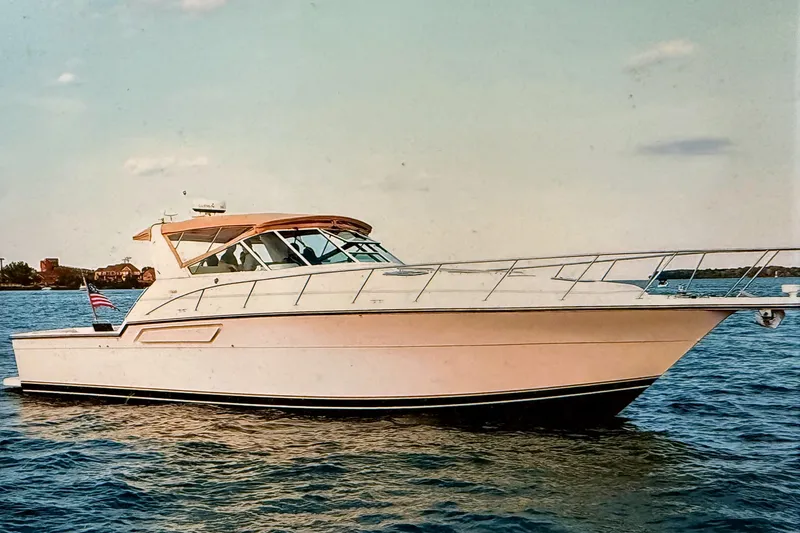 The Image of 1994 Tiara Yachts 4300 Open cruising on calm waters under a clear sky. - 0