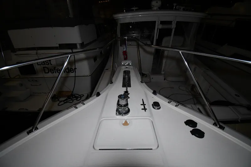 Slide: The Image of 1994 Tiara Yachts 4300 Open deck with railing and winch in marina. - 1