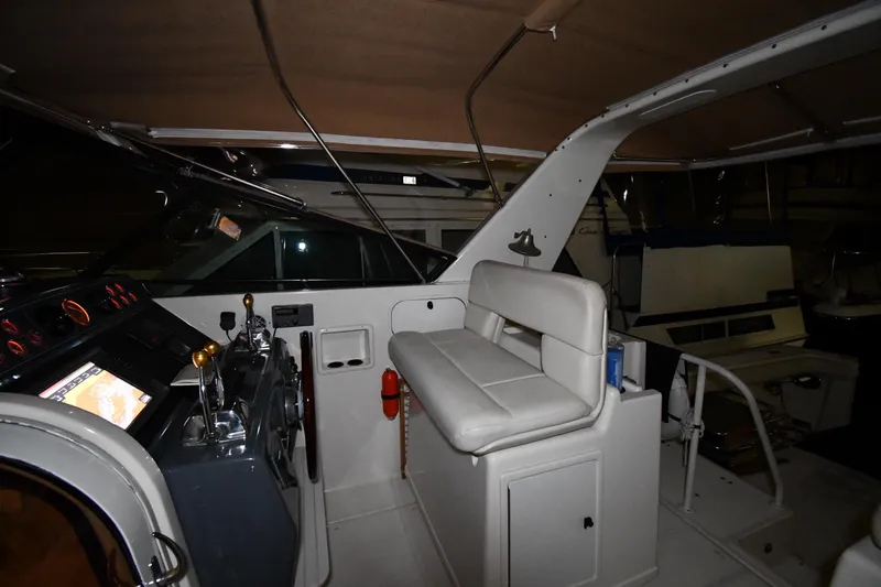 Slide: The Image of 1994 Tiara Yachts 4300 Open cockpit with helm, seating, and navigation controls. - 12