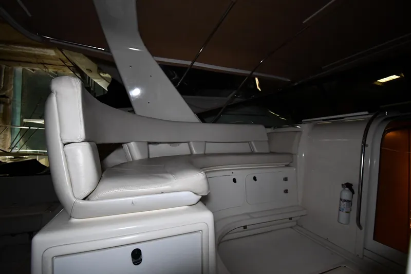 Slide: The Image of 1994 Tiara Yachts 4300 Open interior with white seating and storage compartments. - 13