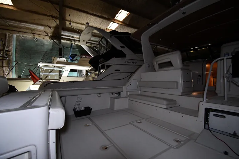Slide: The Image of 1994 Tiara Yachts 4300 Open in a dimly lit indoor storage area. - 15