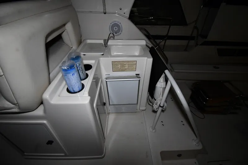 Slide: The Image of 1994 Tiara Yachts 4300 Open interior with sink, mini fridge, and cup holders. - 18