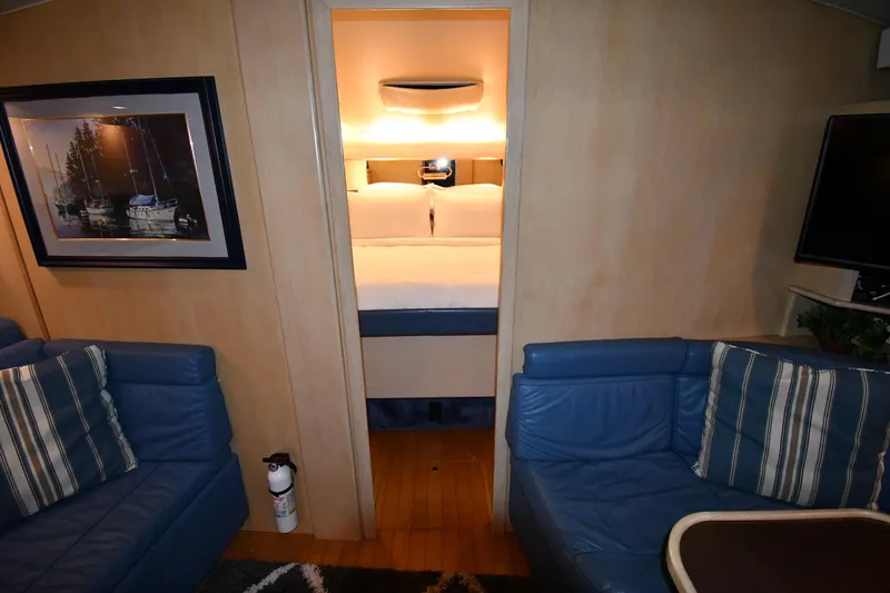 Slide: The Image of Interior of 1994 Tiara Yachts 4300 Open with cozy seating and bedroom view. - 21