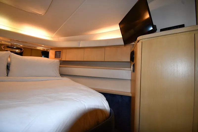 Slide: The Image of Luxurious cabin interior of 1994 Tiara Yachts 4300 Open with cozy bed and TV. - 23