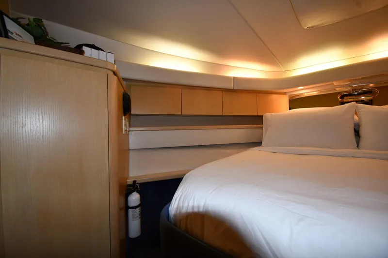 Slide: The Image of Cozy cabin interior of 1994 Tiara Yachts 4300 Open with bed and wooden cabinetry. - 24