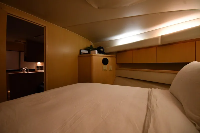 Slide: The Image of 1994 Tiara Yachts 4300 Open cabin interior with bed and wooden cabinetry. - 25