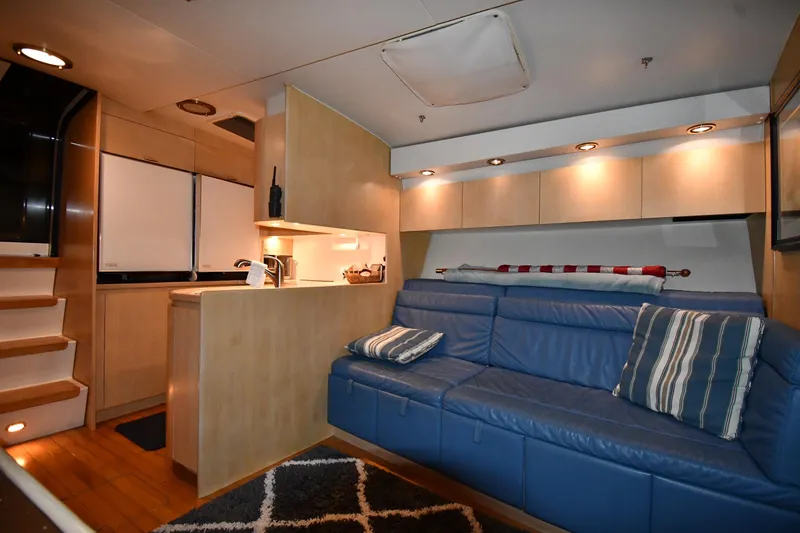Slide: The Image of Luxurious interior of a 1994 Tiara Yachts 4300 Open with blue seating and modern kitchen. - 29