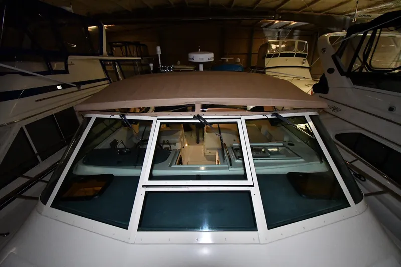 Slide: The Image of 1994 Tiara Yachts 4300 Open in storage, showcasing front deck and windshield. - 3