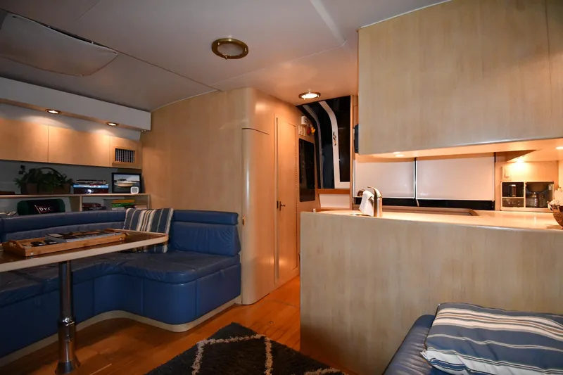 Slide: The Image of Luxurious interior of 1994 Tiara Yachts 4300 Open with blue seating and modern kitchen. - 30