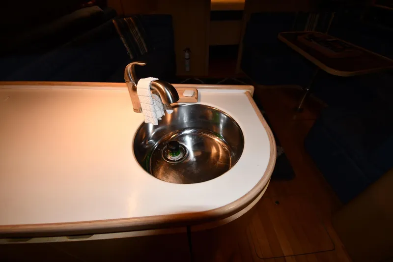 Slide: The Image of 1994 Tiara Yachts 4300 Open interior with a compact sink and countertop. - 32