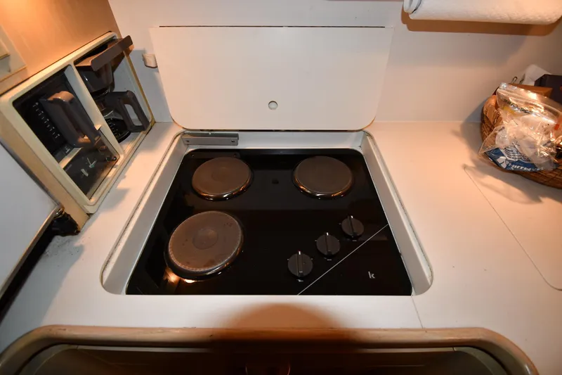 Slide: The Image of 1994 Tiara Yachts 4300 Open kitchen with electric stove and countertop. - 34