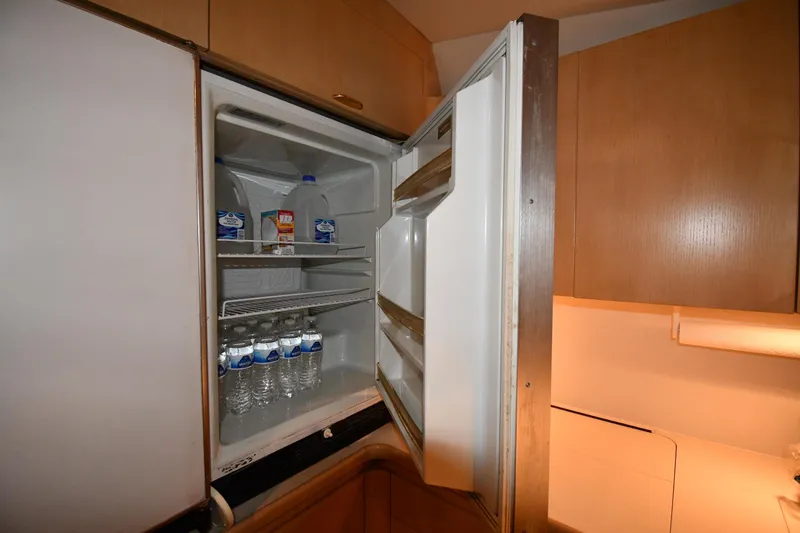 Slide: The Image of Open refrigerator in 1994 Tiara Yachts 4300 Open, stocked with water and milk. - 35
